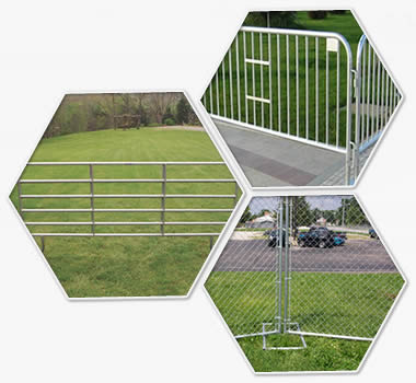 crowd control barrier, chain link temporary fence and corral panels on the grasslands.