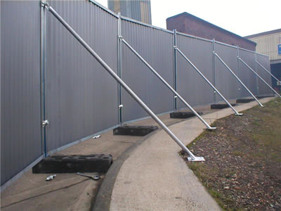 The straight steel bracing supports the temporary hoardings.