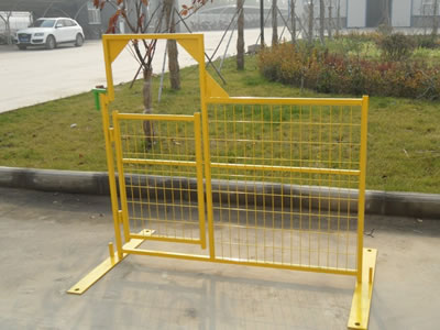 A yellow Canada temporary fence panel with a pedestrian gate. They stand on the floor through the flat metal feet.