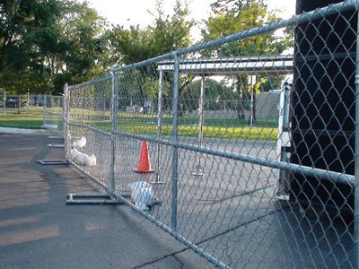 Galvanized chain link temporary fencing erected around a construction site.