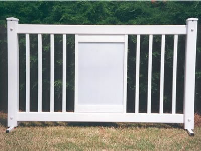 A white display type event fencing panel on the lawn.