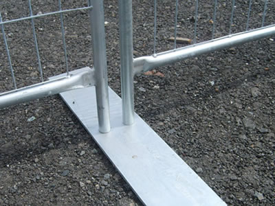 A flat galvanized temporary fence steel feet is installed with two welded temporary fence panels.