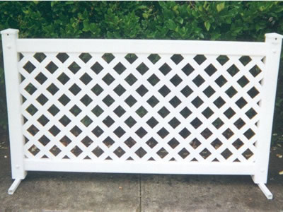 A white lattice type event fencing panel on the ground.
