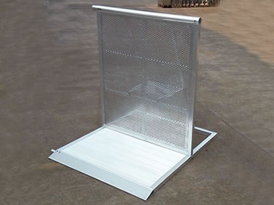 An aluminum stage barrier on the ground with perforated sheet front panel.
