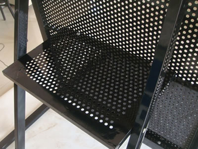 A black powder coated stage barrier has a foot board at the back of the front panel.