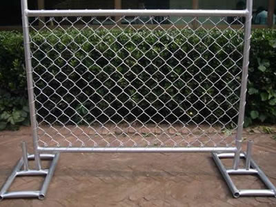 A small size galvanized chain link temporary fencing panel standing on the ground with the metal stand support.
