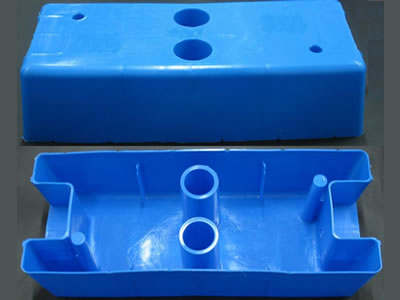 Two blue injection moulded temporary fence feet on the floor. We can see their positive and back sides.